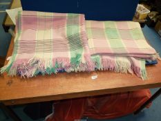 A pair of green, cream and pink Woolen Blankets with fringing.