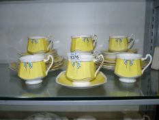 A Heathcote part teaset including two cake plates, ten side plates, nine saucers and seven cups,