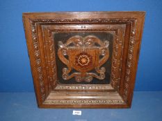 A Victorian wall panel finely carved in various woods in the historic style,