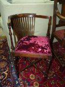 An Edwardian Mahogany framed Armchair having turned legs and arm supports,