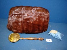 A Mink hand muff with internal pocket for miniature brass warming pan with turned handle.
