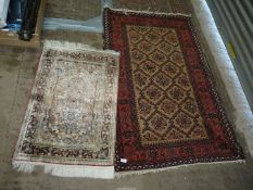 A brown and burgundy border pattern and fringed rug,