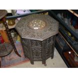 A folding octagonal occasional Table with carved top and base, 19" tall x 19" diameter.