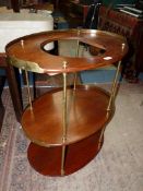 A Victorian oval teak and brass three tier Campaign Washstand having low brass upstand to the upper