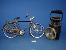 A black B.R. lamp and a small display bicycle.