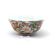 A collectible Chinese porcelain bowl decorated in bright enamels with coiling dragons,