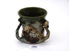 A three handled Tankard with scene depicting oriental figures.