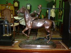 A large cast Bronze figure of a racehorse and jockey, no visible signature or stamp,