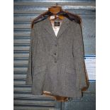 A green/grey tweed hacking Jacket by Derby House, Newburgh, size 12 with original protective cover,