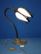 A table lamp with ornate floral metal base and with mottled white and pink glass bud shaped shade,
