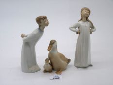 Two Lladro figures of boy and girl, approx. 8 1/2" tall, plus unmarked figure of Duck and duckling.