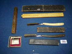 A quantity of miscellanea to include a boxed slide ruler, two cut throat razors,