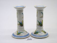 A pair of Continental Candlesticks with a mark to base of a scrolling capital R with tiny cross