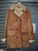 A gents Sheepskin Coat with button front, and large pockets, by Shearlings International, size L.