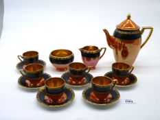 A Carlton ware coffee set, orange and black with gold interior including six cups and six saucers,