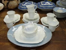 A Shelley white ground part Teaset comprising cake plate, six cups and saucers (one cup a/f.