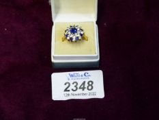 A pretty 9ct gold ring set with blue and white stones.