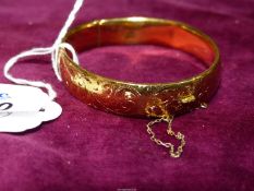 An attractive 9ct gold metal cored Bangle with safety chain. 20 micron.