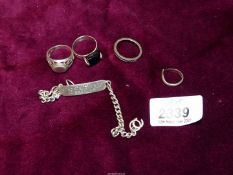 A narrow silver Identity Bracelet, three silver rings and one other.