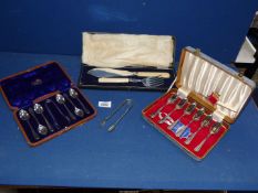 A set of Boxed fish servers with silver collars, cased teaspoons and sugar tong set,