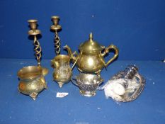 A brass teapot, sugar bowl and jug, pair of candlesticks, six white metal napkin rings,