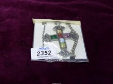 A large Celtic cross on chain with six multi coloured stones.