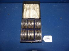A boxed set of six silver Napkin rings, Birmingham 1931, makers W.J.M. & Co.