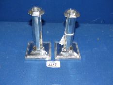 A pair of Silver Candlesticks with panelled columns on stepped square bases with beaded decoration,