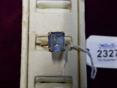 A 9ct gold ring set with a stone of aquamarine colour. Marked within "Syn/St". Ring size"T" approx.