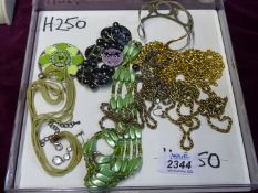 A tray of costume jewellery including five gold coloured chains, two bracelets, ring,