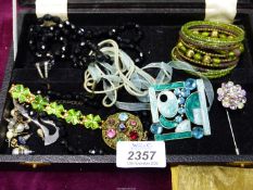 A small quantity of costume jewellery including enamelled pendant, black bead necklace, brooch,