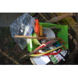 A tub of tools, bow saw, hammers, saws, rake, chimney sweep brush head, etc.