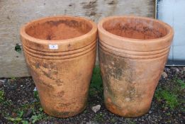A pair of terracotta pots, 18'' high x 15'' wide.