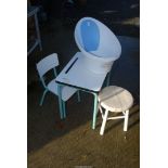 A baby bath and child's desk with chair and stool.