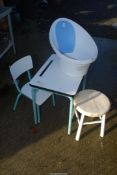 A baby bath and child's desk with chair and stool.