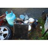 A quantity of paint, spark guard, empty gas cylinder and a car radiator.