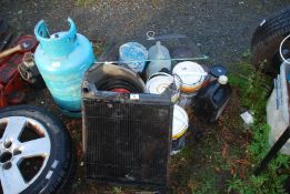 A quantity of paint, spark guard, empty gas cylinder and a car radiator.