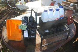 A caravan step, four bottles of Blue Star antifreeze and a small jerry can with funnel.
