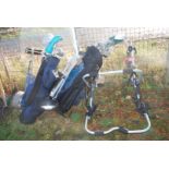 Two sets of golf clubs and a rear bike carrier for three bikes