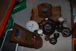 A Ford clock and a quantity of shields.