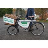 A Granville style Delivery Bicycle with basket and signage.