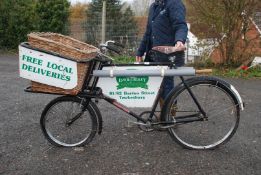A Granville style Delivery Bicycle with basket and signage.