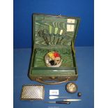A green leather covered manicure box with contents of sewing items to include; thimbles,