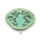 A pretty Christmas shaped majolica Dish decorated with a robin and holly, late 19th c.