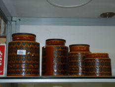 Four Hornsea storage jars, (one lid missing, one chipped).
