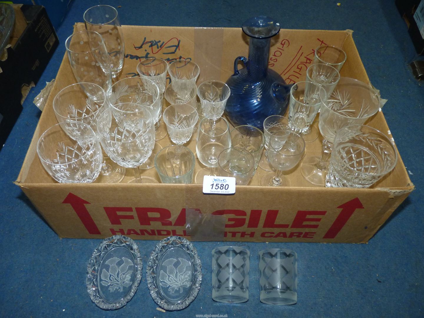 A quantity of glasses including Edinburgh and Stuart Crystal, champagne flutes and blue glass jug.