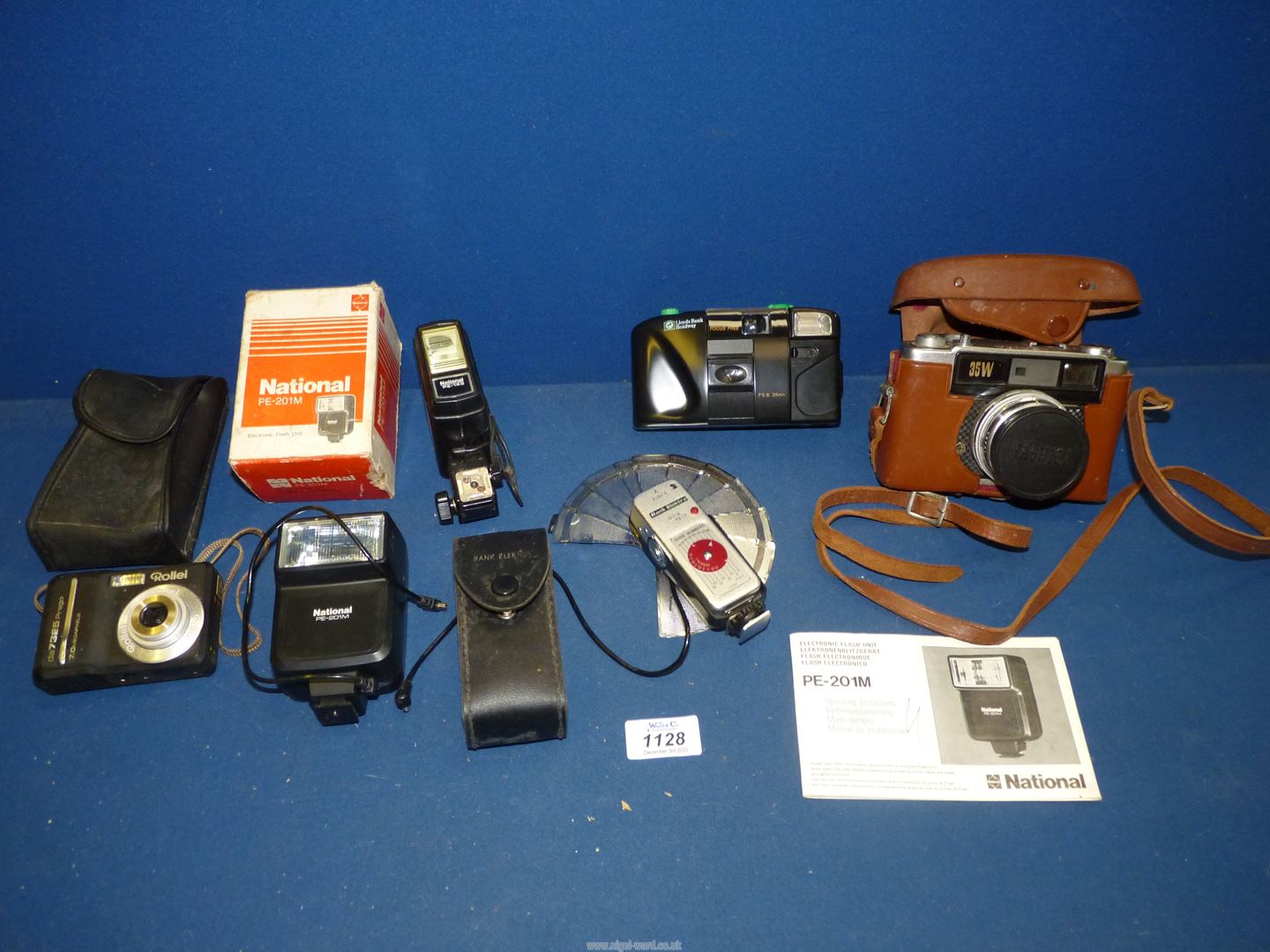 A Yashica 35w camera with case and a quantity of electronic flash units.