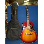 A flame red and orange Columbus Acoustic Guitar in soft black Livivo bag.