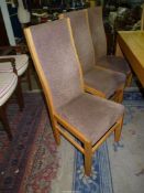 A set of eight light Oak show framed high back Dining Chairs standing on tapering square legs and