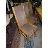 A set of eight light Oak show framed high back Dining Chairs standing on tapering square legs and